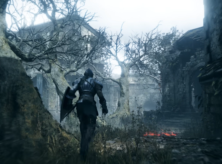 a screenshot of the game Demon Souls that shows a character in metal armour walking through a dead forest